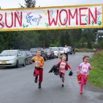 Seamus McDonough, 8, Bea McDonough and Eryn Field, 8, dash across the finish line at Sunday’s Breast Cancer Run.-Photo by McKibben Jackinsky,  Homer News