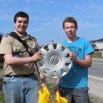 A VW hubcap is one item collected during Cleanup Day that Marshall Fuller, left, and Andrew Anderson of Boy Scout Troop 365 decided not to throw away.-Photo by McKibben Jackinsky, Homer News