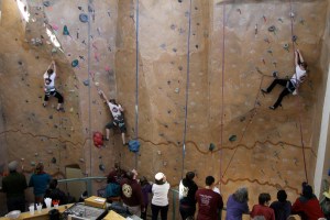 Climbers Clare Cook, Shiloh Miller and Renata Miller search for routes on the Bay Club climbing wall. -Photo by Angelina Skowronski