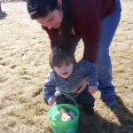 Thomas Wetherill gets help with his full basket from mom, Vanessa.-Photo by McKibben Jackinsky, Homer News