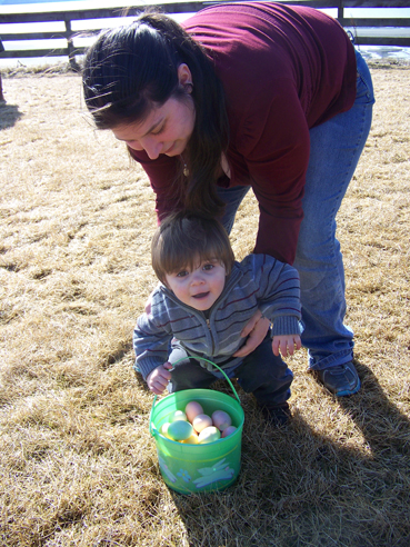 Thomas Wetherill gets help with his full basket from mom, Vanessa.-Photo by McKibben Jackinsky, Homer News