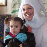 Kaylee Kvasnikoff and the Easter Bunny visit at Emblem Club on Easter.-Photo by McKibben Jackinsky, Homer News