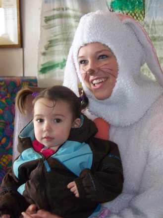 Kaylee Kvasnikoff and the Easter Bunny visit at Emblem Club on Easter.-Photo by McKibben Jackinsky, Homer News
