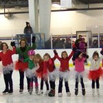 Figure skaters take a bow before cheering fans during a December 2013 event at the Kevin Bell Arena. From left: Madilyn Illg, Cara Clemens, Sylvia Clemens, Thea James, Tianah Cavanaugh, Rhonda Velsko, Sabre Wilmeth, Keagan Niebuhr, Natalia Sherwood, Natalie Farren, Courtney Galloway, Evelyn Sherwood, coach: Natalie Betley, Mia Hemphill, assistant: Priscilla Andrade.-Photo by McKibben Jackinsky, Homer News