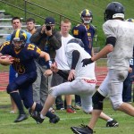 Mariner Ian Lowe maintains possession of the football during Homer High School’s scrimmage on Saturday with the Voznesenka Cougars.-Photo by McKibben Jackinsky, Homer News