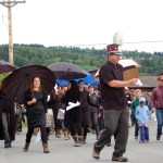 The Bossy Panties dancers and the Bossy Pants band and friends and family of Ray Garrity hold a second-line procession for him from Homer High School to Pioneer Avenue on Monday afternoon.-Photo by Michael Armstrong, Homer News