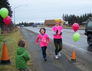 Nicole Vendenaal completes Saturday’s 5K Girls on the Run with her running buddy, Britni Johnson. The program for  girls in grades three-five aims at educating and inspiring them for a lifetime of self-respect and healthy living.-Photos by McKibben Jackinsky, Homer News