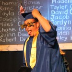 A tongue-wagging Chase Craughters is decked out with a flag on his mortarboard and “2014” frames for his glasses.-Photo by McKibben Jackinsky, Homer News