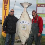 Christopher Johnson, left, with Capt. Scott Glosser, is the current leader in the 2013 Homer Jackpot Halibut Derby. -Photo provided
