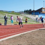 Ethan Pitzman gets ready to cross the finish line of the 800-meter dash, with Peter Syth close behind in second place. The Hershey Track and Field Games were held Saturday in Homer for the first time in several years, attracting 18 youths between the ages of 9 and 14.-Photo by Heather Ericson