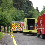 Firefighters check hose lines at the Rainbow Court fire.-Photo by Michael Armstrong, Homer News