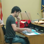 Homer City Council candidate Justin Arnold examines and hand counts ballots on Tuesday at the start of a recount as deputy city clerk Melissa Jacobsen watches. His recount was unofficial, and elections officials used a machine recount.-Photo by Michael Armstrong, Homer News
