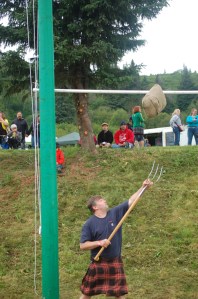 Homer Volunteer Fire Department firefighter Joe Sallee tosses the sheaf at the Kachemak Bay Scottish Highland Games last year. Sallee wears the firefighter tartan.-Homer News file photo