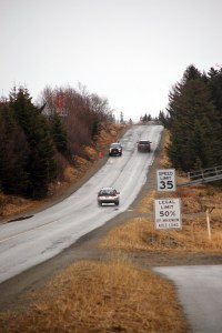 Cars drive up a steep hill on Kachemak Drive just beyond where the Homer Spit Trail ends, at lower right. A study suggested a nonmotorized path that would extend the Spit Trail to the bottom of the hill and then follow the beach along Mud Bay.-Photo by Michael Armstrong, Homer News