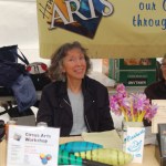 Christa Collier staffs the Homer Council on the Arts booth.-Photo by Michael Armstrong, Homer News