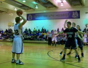 Mariner Mark McGregor, No. 32, gets ready to pass the ball during Saturday's final tournament game against the Nikiski Bulldogs. The Mariners claimed a 50-35 victory in the game that was played in the Homer Middle School gym.-Photo by McKibben Jackinsky, Homer News