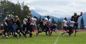 Mariner quarterback Sheldon Hutt fights to maintain a grip on the ball before being taken down by Kardinal running back Chase Daniels. -Photo by McKibben Jackinsky, Homer News
