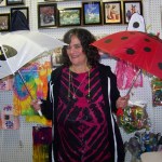 Deb Greeson of Alaska Crystal Cache did a booming business selling umbrellas at the Kenai Peninsula Fair on Friday.-Photo by McKibben Jackinsky, Homer News