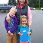 Accompanied by their grandmother, Heidi Spencer, second-grader Troy Neese and his sister Synnove, in kindergarten, are ready to begin classes at Paul Banks Elementary School. -Photo by McKibben Jackinsky, Homer News