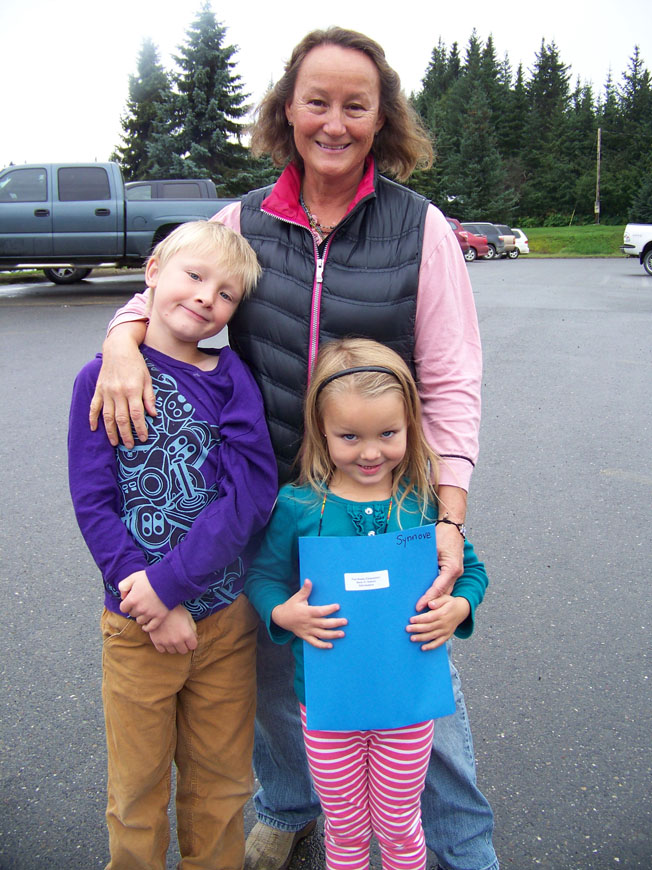 Accompanied by their grandmother, Heidi Spencer, second-grader Troy Neese and his sister Synnove, in kindergarten, are ready to begin classes at Paul Banks Elementary School. -Photo by McKibben Jackinsky, Homer News