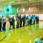 Homer Middle School faculty and staff, led by Tim Daugharty, show students how to do the Husky howl at a first-day assembly on Tuesday.-Photo by McKibben Jackinsky, Homer News