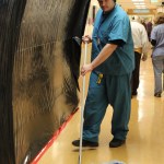 Homer High senior Ian McCormick battles dirt in South Peninsula Hospital’s hallways.-Photo by McKibben Jackinsky, Homer News