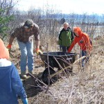 Todd Schroeder of the Homer Soil and Water Conservation District, second from left, works with third-grade trail crew Robby Venendaal, left; Keith Roderick, second from right; and Henry Lemieux, right.-Photo by McKibben Jackinsky, Homer News