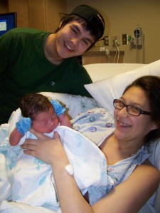Nikalai Norman, top, and and Barbara Swenning, right, show off their new son, Titan Kasius Swenning Norman.-Photo by McKibben Jackinsky, Homer News