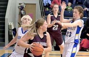 Nikolaevsk's Sophia Kalugin, 13, gets a rebound during their game against the Cook Inlet Academy Thursday Dec. 19, 2013 in Soldotna, Alaska. Nikolaevsk won the game 27-26. Nikolaevsk's Nianiella Dorvall, 23, keeps an eye on the action.  -Photo by Rashah McChesney/Peninsula Clarion