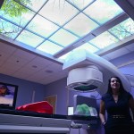 Jan Weiler, department manager of the Radiation Oncology Center at Central Peninsula Hospital, stands near a linear accelerator in the Soldotna center’s radiation therapy vault during the center’s opening ceremony last week.-Photo by Rashah McChesney, Morris News Service - Alaska