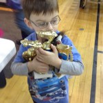 Four-year-old Jackson Woodhead claims trophies he received during the Snow Rondi’s pinewood derby. He also went home with an armload of trophies, ribbons and candy bars he won in ski events.-Photo provided