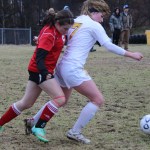 Hannah Baird, right, fends off a member of Wasilla’s soccer team during last Friday’s game.-Photo by McKibben Jackinsky, Homer News