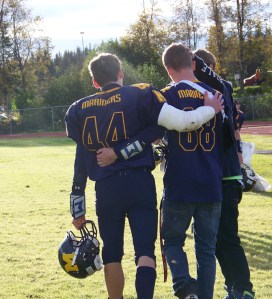 Senior Gabriel Selbig, 44, and junior Drew Brown, 68, leave the field after the Homer Mariners’ loss to the Lathrop Malemutes. This was Selbig’s first game after being injured earlier in the season. Brown also was sidelined with injuries.  -Photo by McKibben Jackinsky,  Homer News