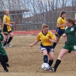 Mariner Sydney Lee, center, goes toe-to-toe against a Colony player. -Photo by McKibben Jackinsky, Homer News