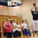 Matt Garrison,  right, gives a group of girl basketball players tips at a shooting clinic last Friday.-Photo by Michael Armstrong, Homer News