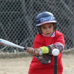 Tegan Garza takes aim at the baseball.-Photo by McKibben Jackinsky, Homer News