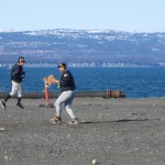 Dick Perez throws the ball during a Mariner practice on the Homer Spit, while Brian Rowe runs. The Mariners’ first game of the season will be May 3 at home.