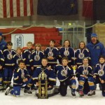 Homer’s Pee Wee C’s gather around their championship trophy from the Power Play Tournament.-Photos by Stephanie Pitzman
