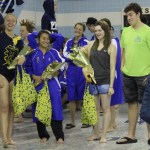 With their teammates in the background, Homer High seniors (left to right) Jenna Fabich, Crystal Crane, Cheyanne Smith and Thomas Vanek are honored during the Homer Invitational swim and dive meet on Saturday.-Photos by McKibben Jackinsky, Homer News