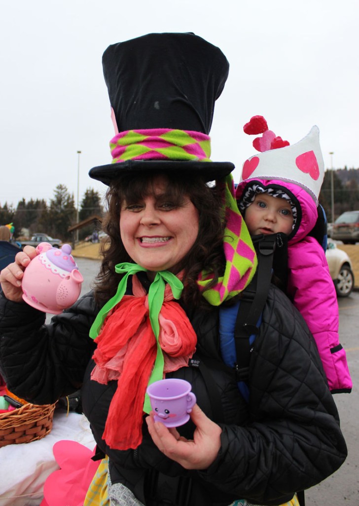 Tiana Hopper and her backpack buddy, Malia, offer a cup of imaginary tea from the Imagination Library parade float. -Photo by McKibben Jackinsky, Homer News