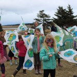 Youngsters display Earth Day prayers flags made with the help of Kiki Abrahamson, in back.-Photo by McKibben Jackinsky, Homer News