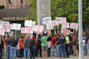 Greg Walker, business manager for United Association of Plumbers and Steamfitters Union Local 367, rallies Enstar Natural Gas Co. employees during a rally in front of the company headquarters in Anchorage on Aug. 11. The union went on strike at 6 a.m. that morning after its Enstar operations employees rejected a contract offer last week.-Photo by Andrew Jensen; Morris News Service - Alaska