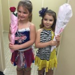 Sisters and figure skaters Kaya and Amika Stinoff take a moment off the ice to have their photo taken during the Riverskate competition in Soldotna.-Photo by Kiirsten Styvar