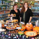 Timeless Toys owner Becky Pheil, right, and her daughter, Marian Ford, serve treats to make any trick-or-treater happy.-Photo by McKibben Jackinsky, Homer News