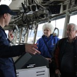 During the Veterans Day open house aboard the USCGC Hickory, Ensign David Parker describes the ship’s communication system to Amy Springer and Edward Blickhahn.-Photo by McKibben Jackinsky, Homer News