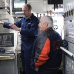 Petty Officer Will Nipp describes control systems aboard the Hickory to Edward Blickhahn during the ship’s open house.