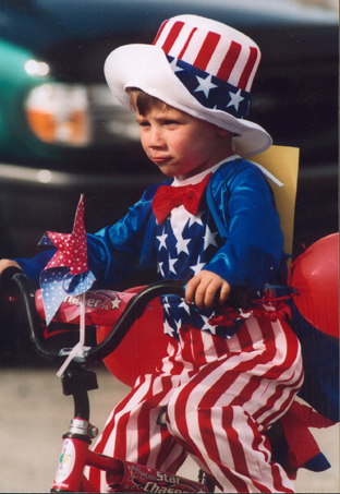 Bradley Bordner rides his tricycle in the 2003 Homer Fourth of July parade.-Homer News archive photo
