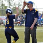 Homer Head Softball Coach Bill Bell high fives senior Miranda Beach as she rounds third base after hitting a home run against Ketchikan in the first round of the small schools state softball tournament Friday, May 31. -Photo by Mike Nesper/Morris News Service - Alaska