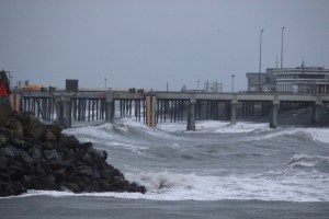 High waves splash against rocks at the entrance to the Homer Harbor.-Photo by McKibben Jackinsky, Homer News