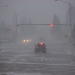 High winds kick up snow at the Lake Street stoplight.-Photo by McKibben Jackinsky, Homer News